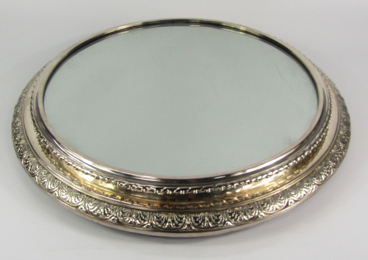 Appraisal: A mahogany silver plate and mirrored circular wedding cake stand