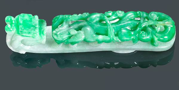 Appraisal: An apple green and white jadeite belt buckle Deftly carved