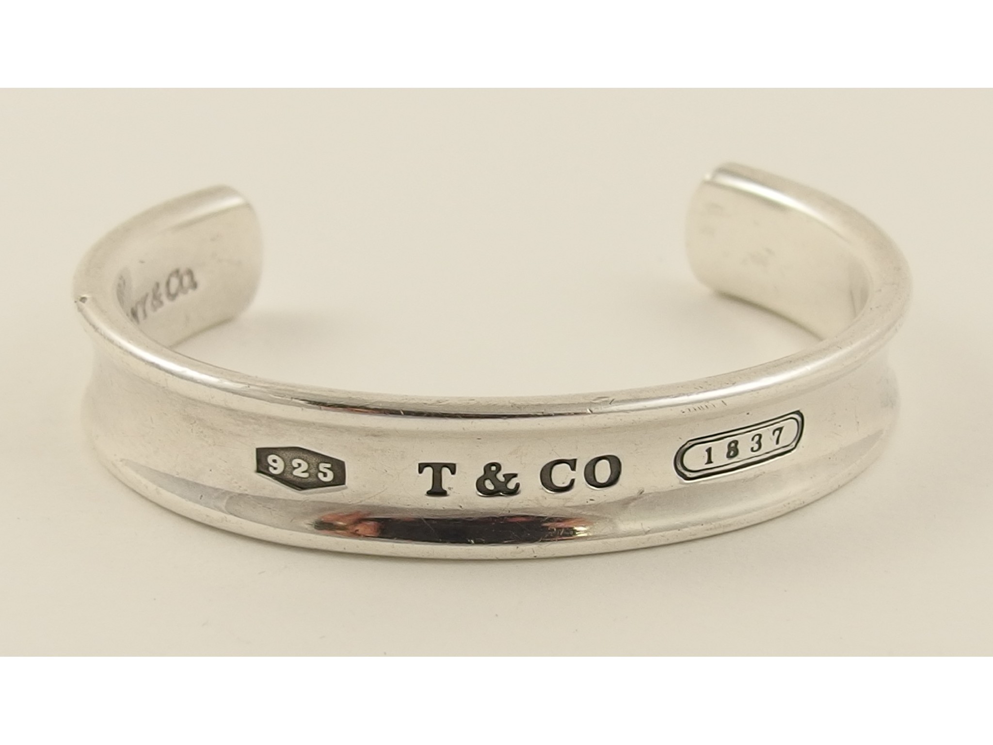 Appraisal: A silver bangle stamped Tiffany the front stamped T Co