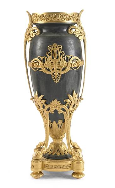 Appraisal: An Empire style gilt and patinated metal vase height in