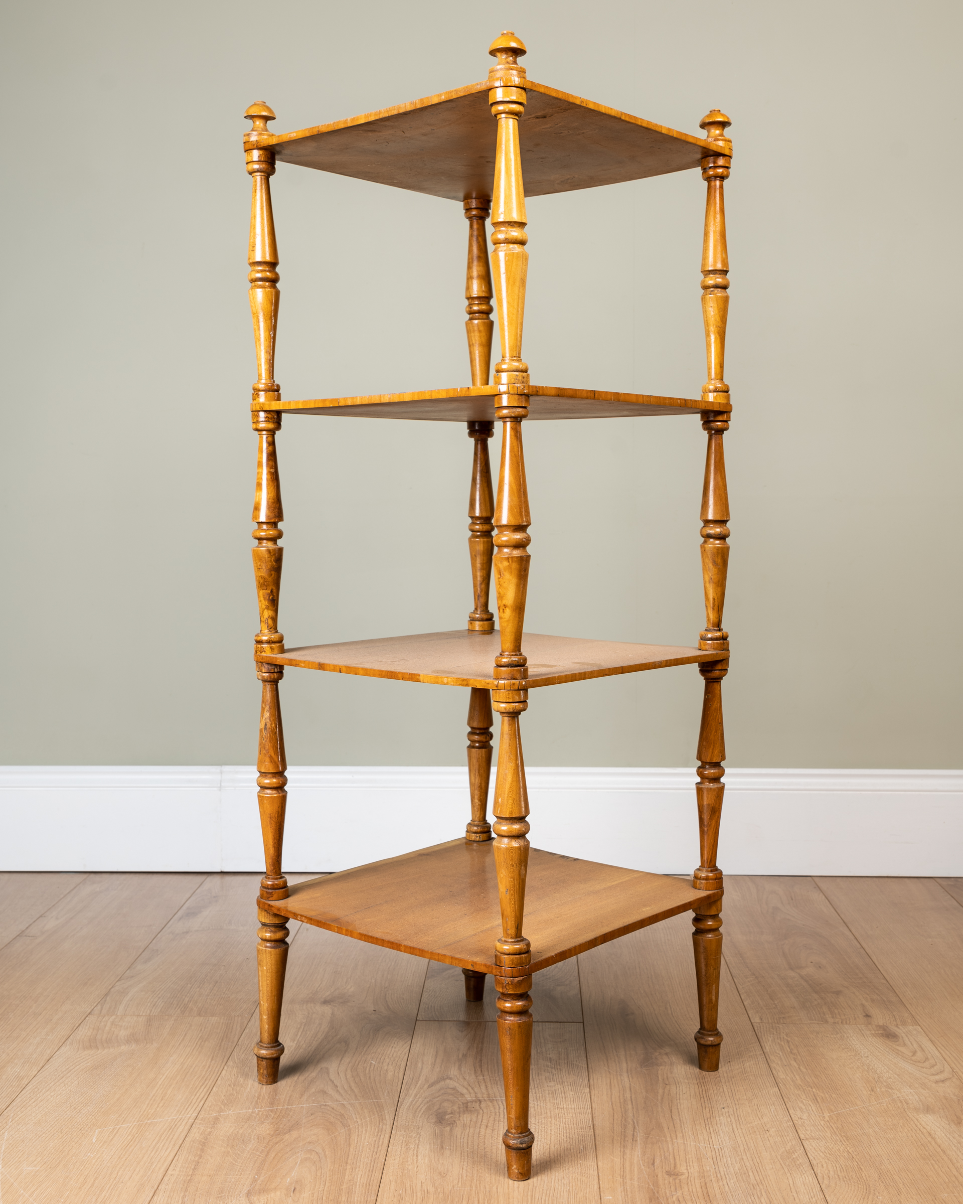 Appraisal: A satinwood four-tier whatnot with turned supports the top cm