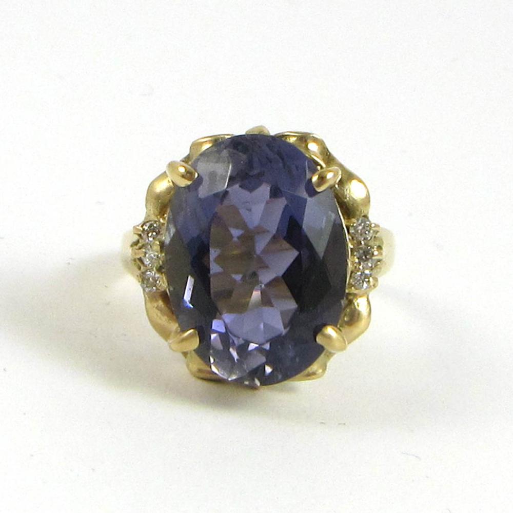 Appraisal: IOLITE DIAMOND AND FOURTEEN KARAT GOLD RING with three round-cut