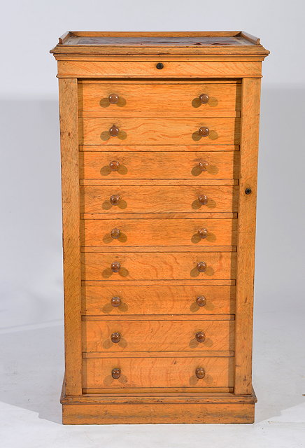 Appraisal: A VICTORIAN OAK SECRETAIRE WELLINGTON CHEST the leather inset top