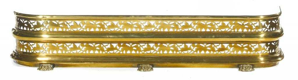 Appraisal: AN EARLY VICTORIAN BRASS FENDER with two pierced bands of