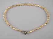 Appraisal: A cultured pearl necklace with a white metal tests silver