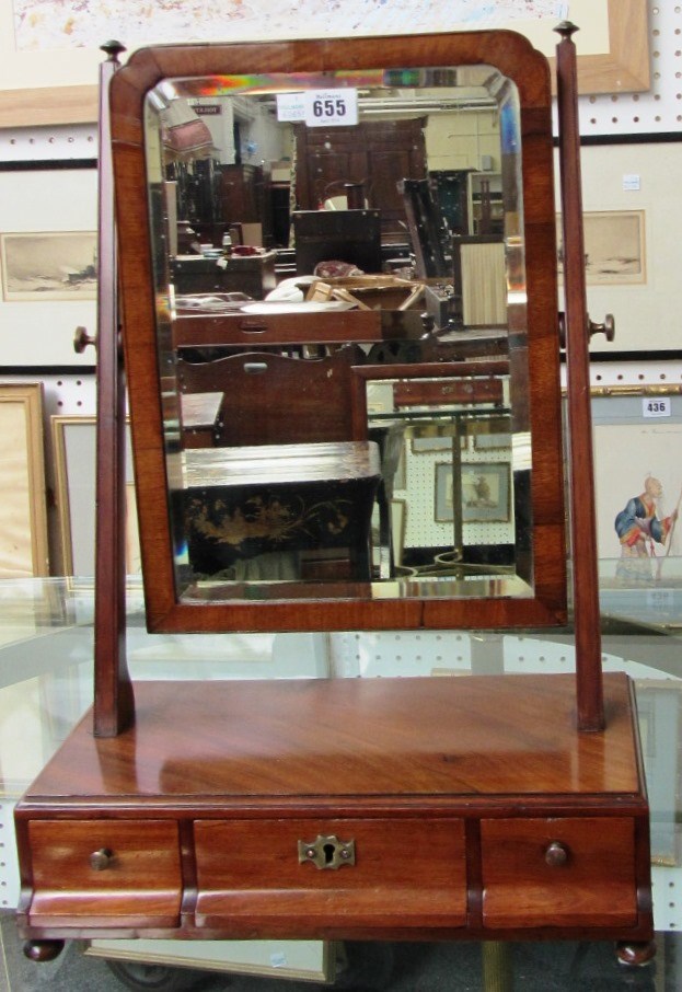 Appraisal: A th century mahogany toilet mirror with triple cushion drawer