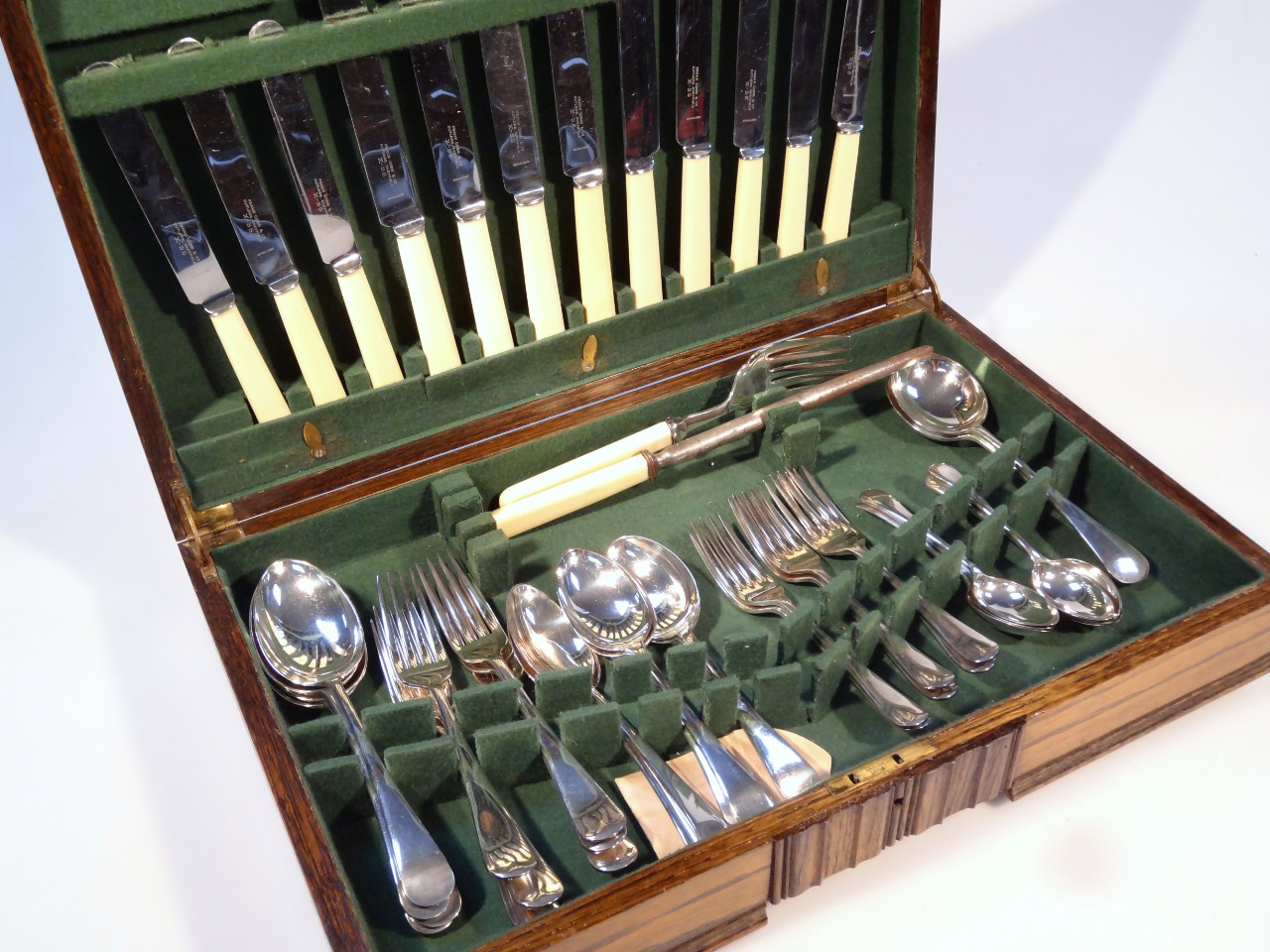 Appraisal: A mid- thC oak canteen containing various plated cutlery settings