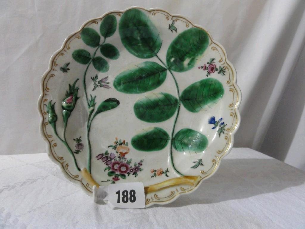 Appraisal: An th century dessert plate with painted and moulded rose