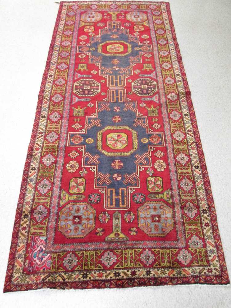 Appraisal: SEMI-ANTIQUE PERSIAN TRIBAL CARPET Caucasian influence double geometric medallion design