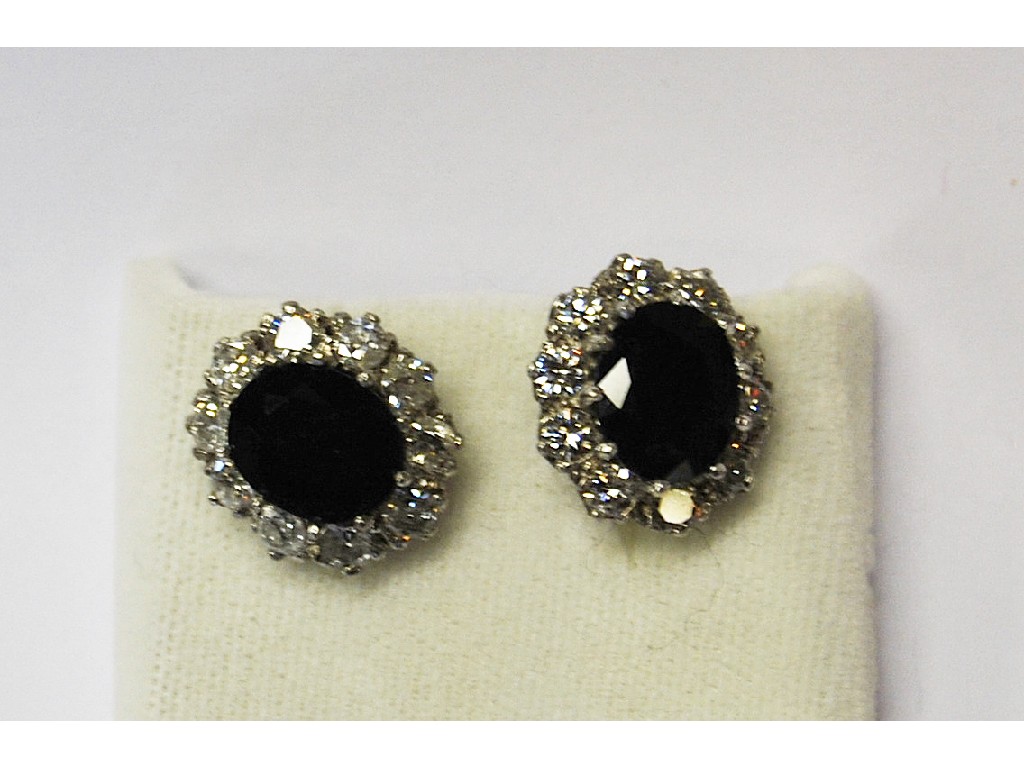 Appraisal: Large oval sapphire and diamond cluster ear studs with central