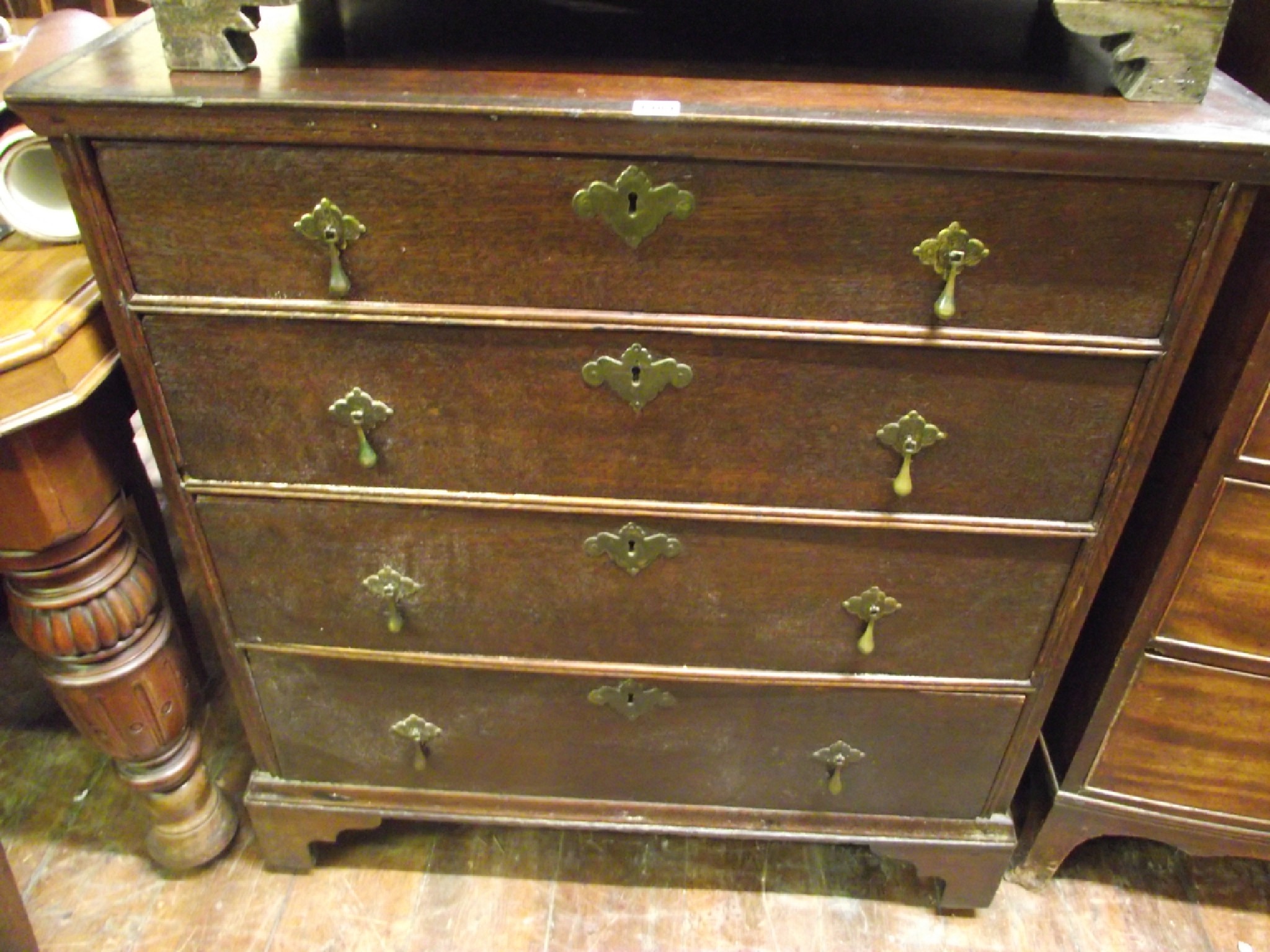 Appraisal: An Old English oak chest of four long graduated drawers