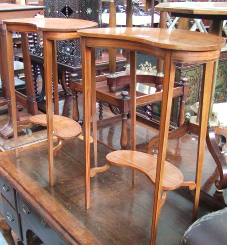 Appraisal: A pair of satinwood kidney shaped occasional tables circa raised