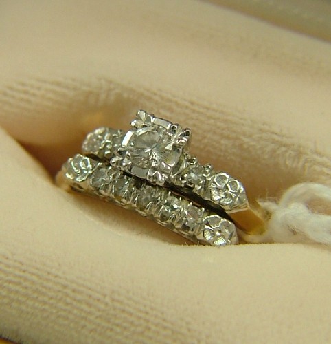 Appraisal: DIAMOND AND FOURTEEN KARAT GOLD WEDDING SET the engagement ring