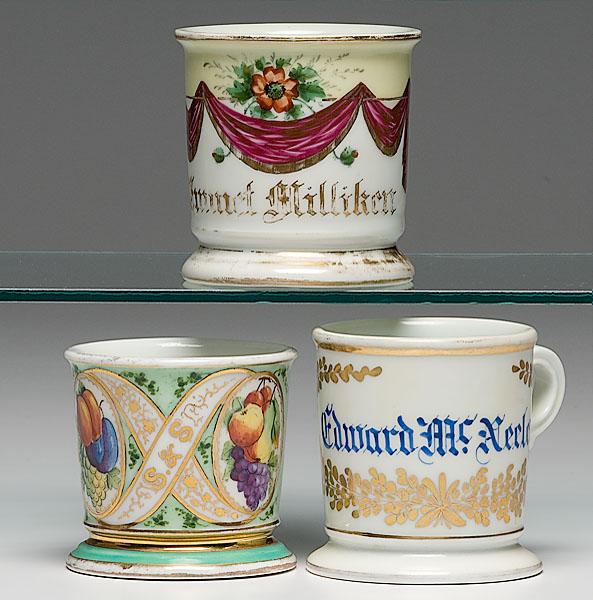 Appraisal: THREE UNUSUAL NAME SHAVING MUGS includes one with yellow monochrome