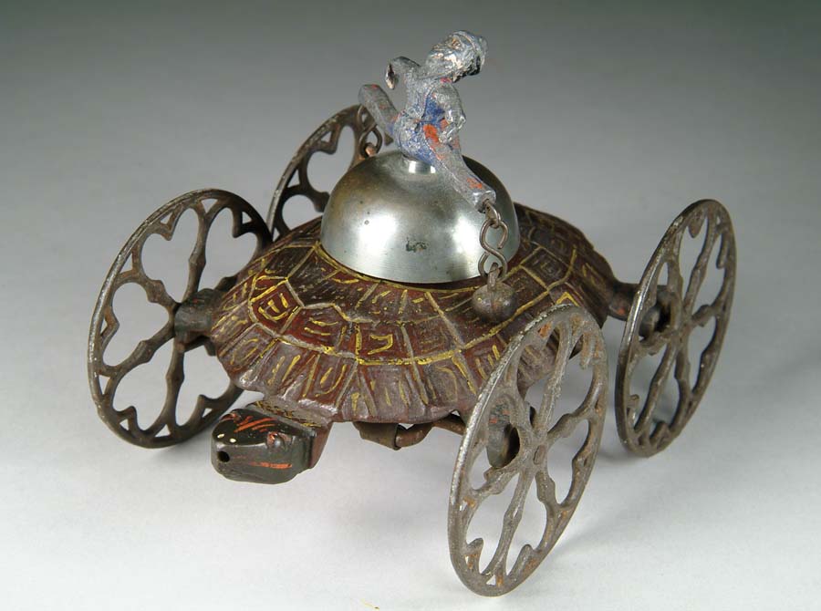 Appraisal: TURTLE AND CLOWN BELL TOY Manufactured by The Gong Bell