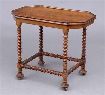 Appraisal: CONTINENTAL BAROQUE WALNUT OCTAGONAL TRAY-TOP TABLE The oblong top with