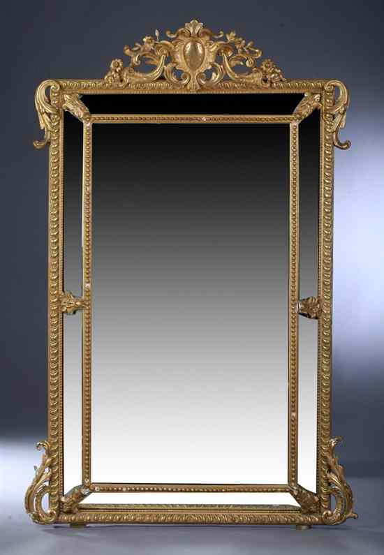 Appraisal: FRENCH STYLE GILT-COMPOSITION WALL MIRROR Foliate carved open-work crest beveled