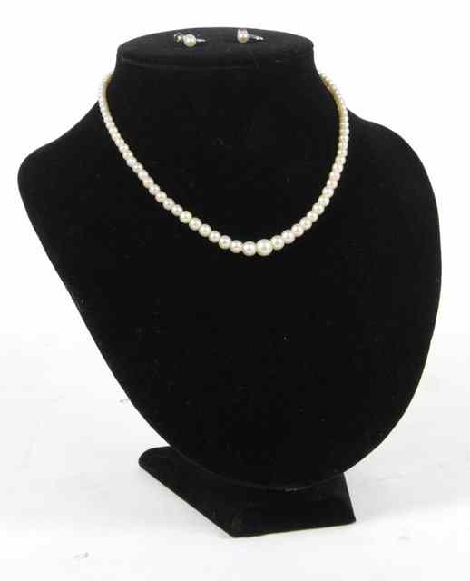 Appraisal: A single strand graduated faux pearl necklace to a marcasite