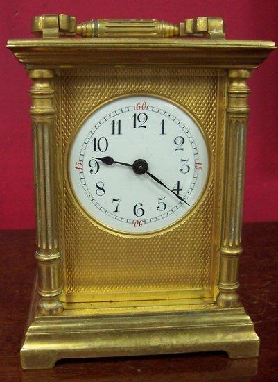 Appraisal: A gilt brass carriage time-piece with handle to the top