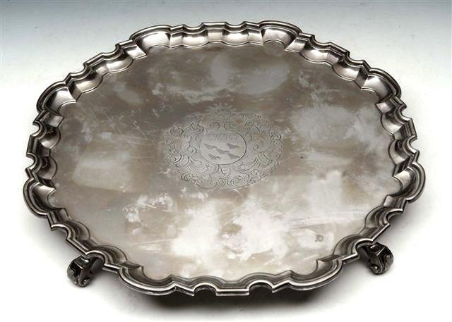 Appraisal: A GEORGIAN STYLE SILVER TRAY with scalloped border on three