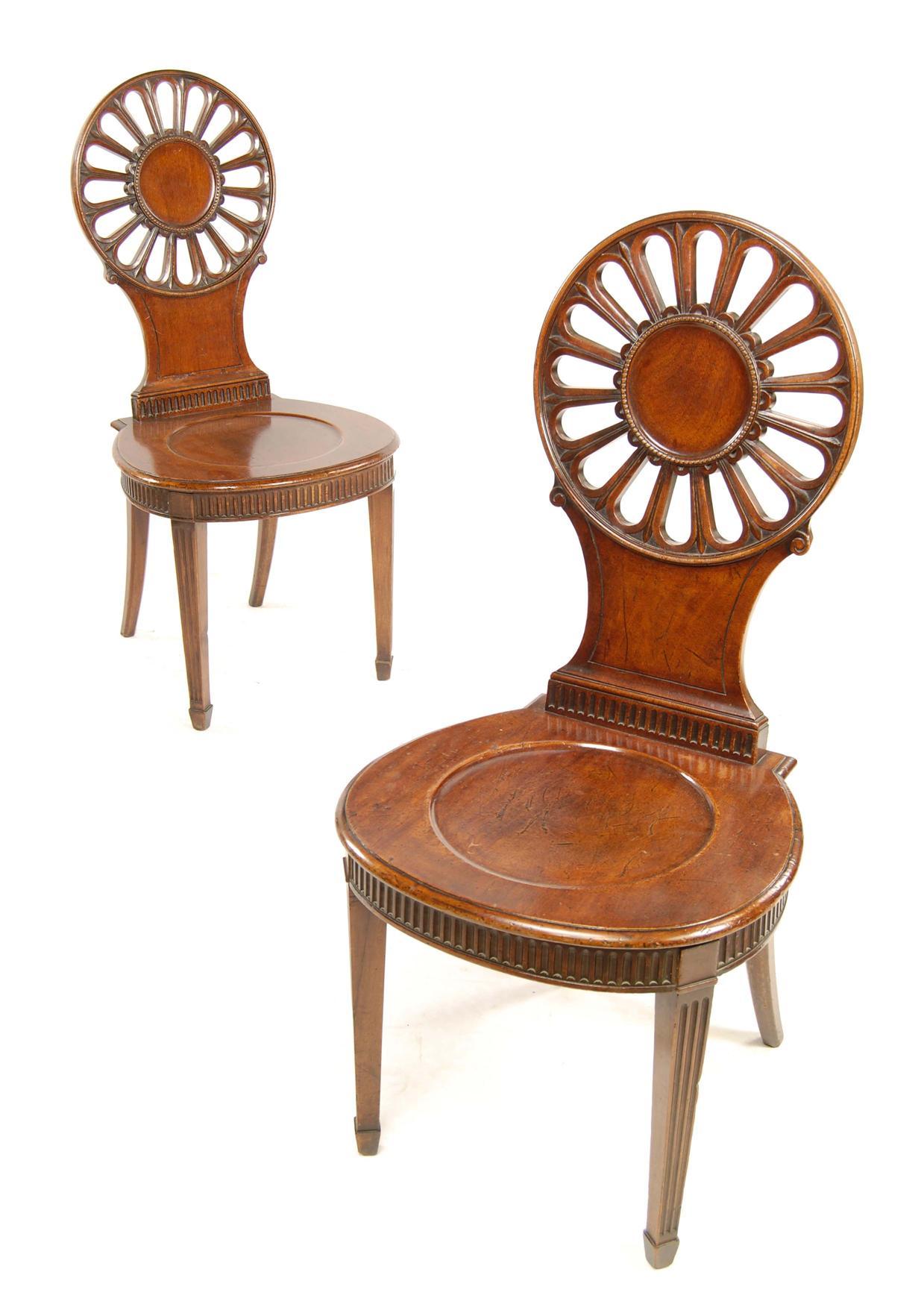 Appraisal: A pair of George III mahogany hall chairs