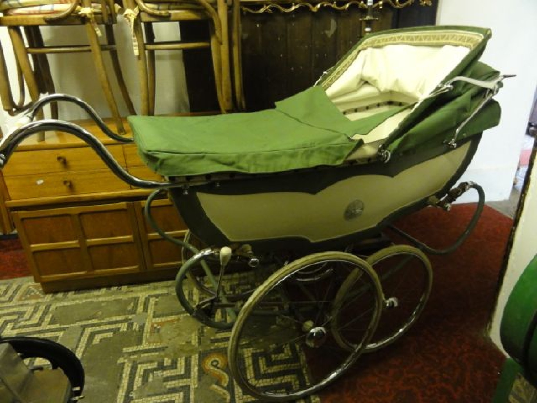 Appraisal: A vintage coach built pram with cream and green colourway