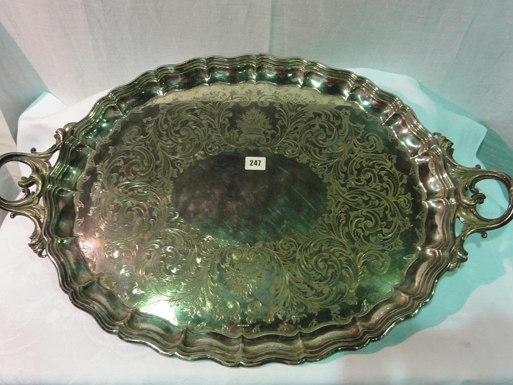 Appraisal: A large two handled tray of oval form with engraved