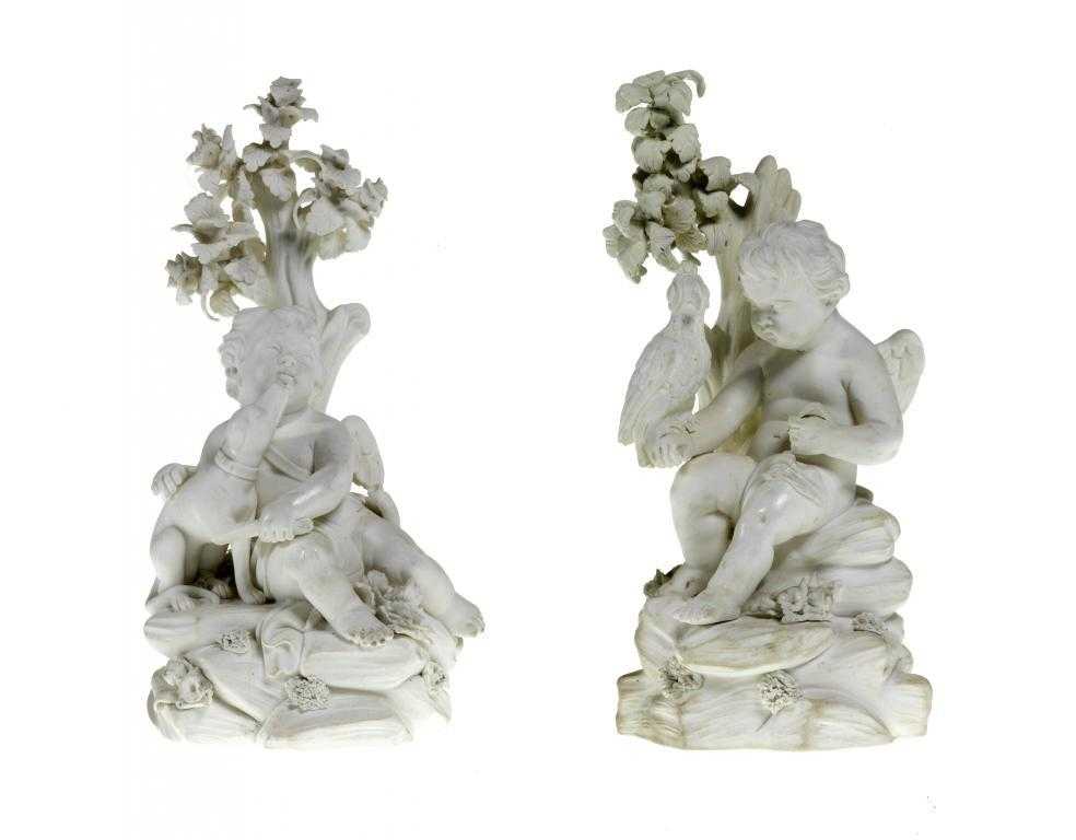 Appraisal: A PAIR OF DERBY BISCUIT FIGURES OF CUPID seated with