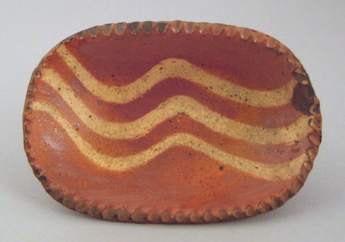 Appraisal: Miniature redware loaf dish th c with yellow slip decoration