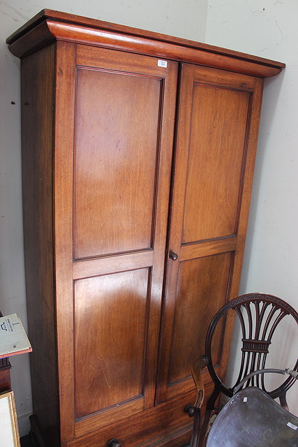 Appraisal: A VICTORIAN MAHOGANY WARDROBE with two panelled doors above single