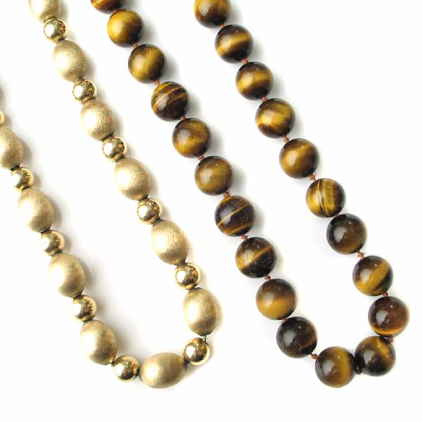 Appraisal: A tiger's eye bead necklace and a k gold bead