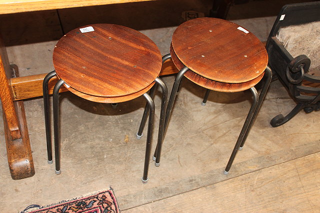 Appraisal: A SET OF FOUR STACKING STOOLS with circular plywood tops