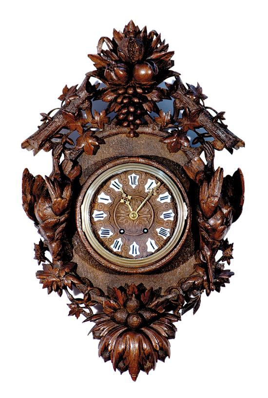 Appraisal: Black Forest carved walnut wall clock circa heavily carved with