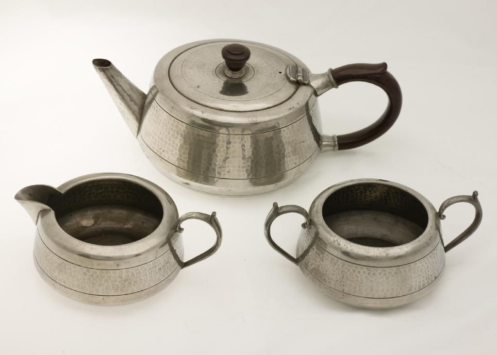 Appraisal: 's THREE-PIECE PEWTER TEA SERVICE each piece with planished finish