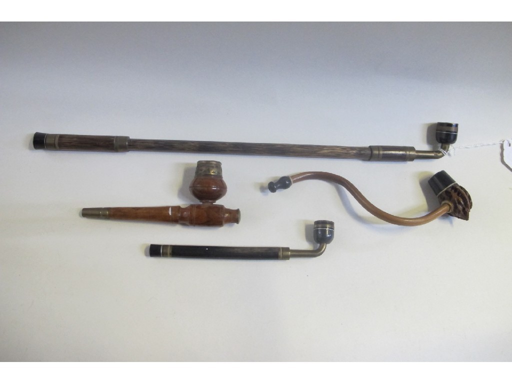 Appraisal: Lot comprising four assorted opium pipes