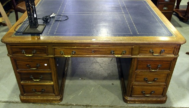 Appraisal: A Victorian style partners desk with tooled leather inset and