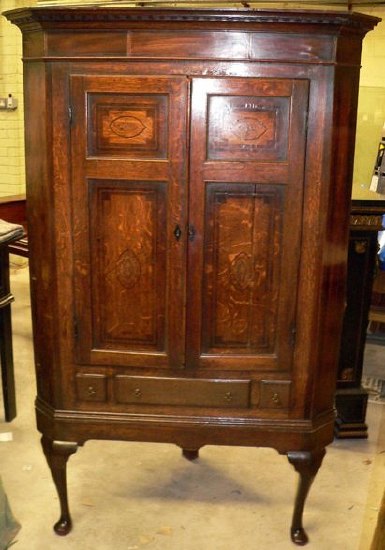 Appraisal: A late th early th Century oak hanging corner cupboard