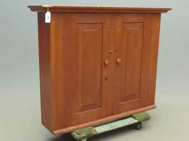 Appraisal: th c two door hanging cupboard in red paint ''