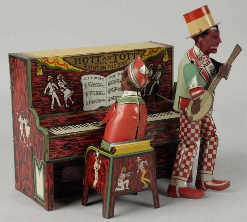 Appraisal: Tin Unique Art Hott Tott Minstrel Band Toy Description American