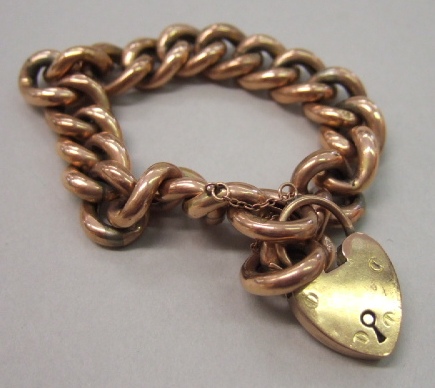 Appraisal: A gold curb ink bracelet on a gold heart shaped