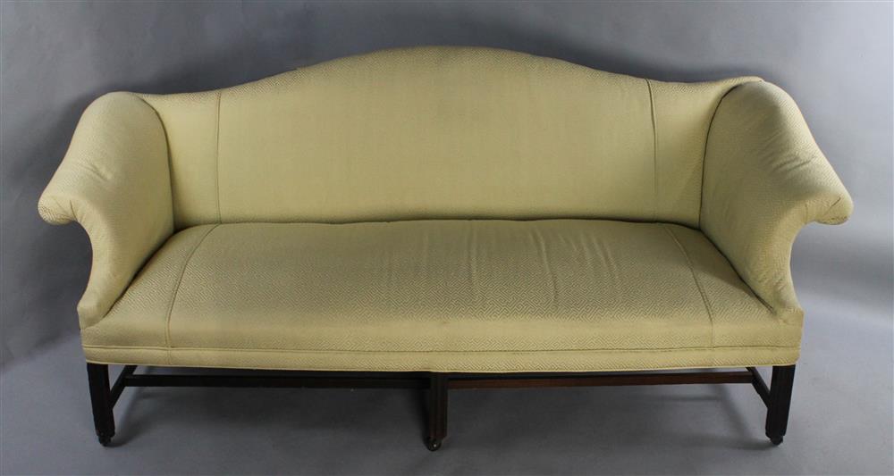 Appraisal: CHIPPENDALE MAHOGANY CAMELBACK SOFA the sweeping arched back with channel