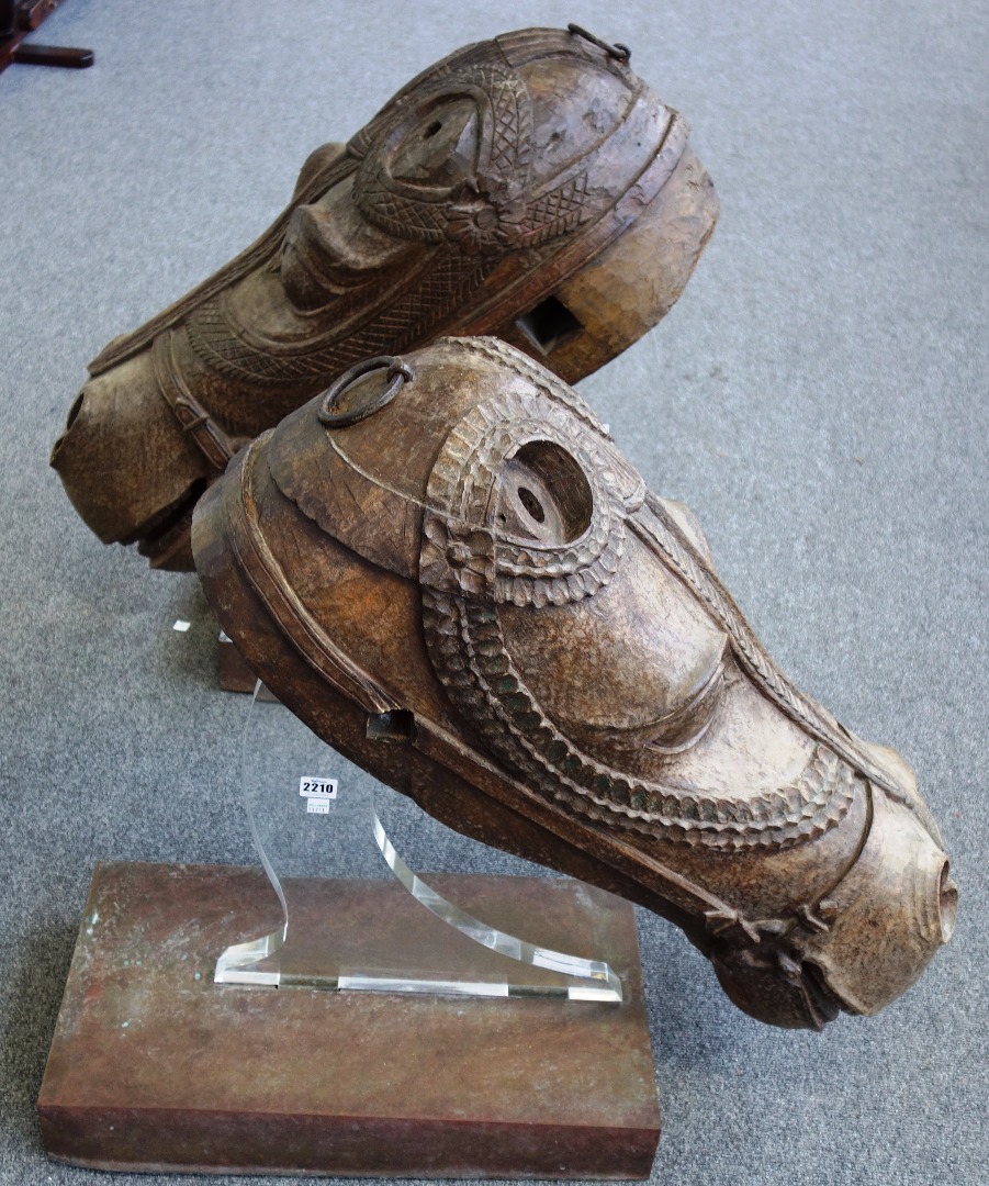 Appraisal: A large pair of Indian carved hardwood horse heads th