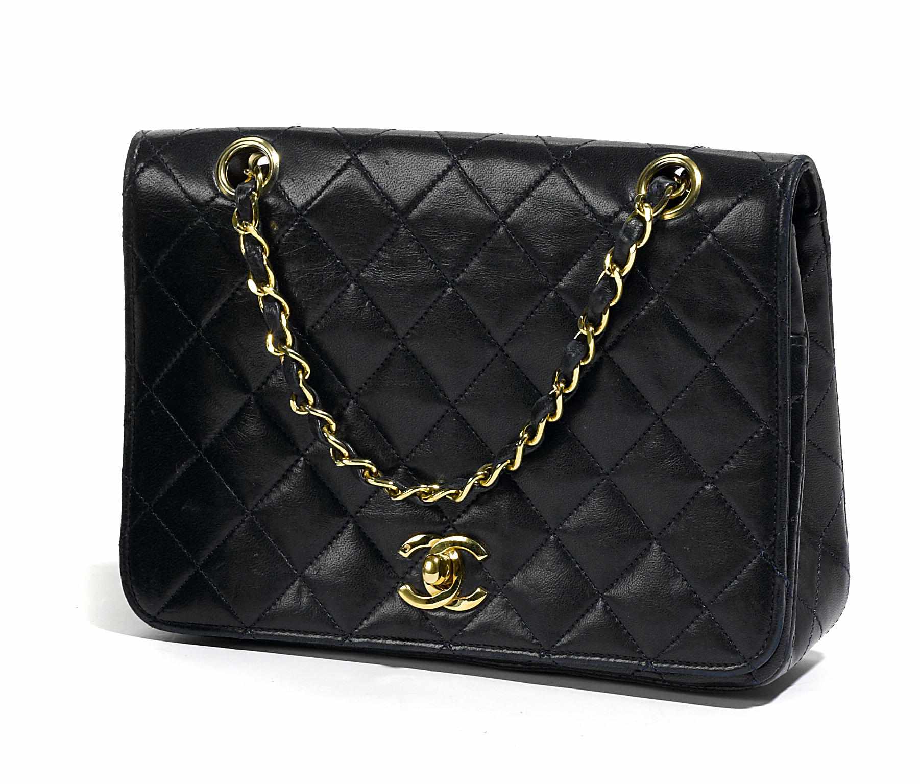 Appraisal: A Chanel black handbag with woven leather and chain handleheight