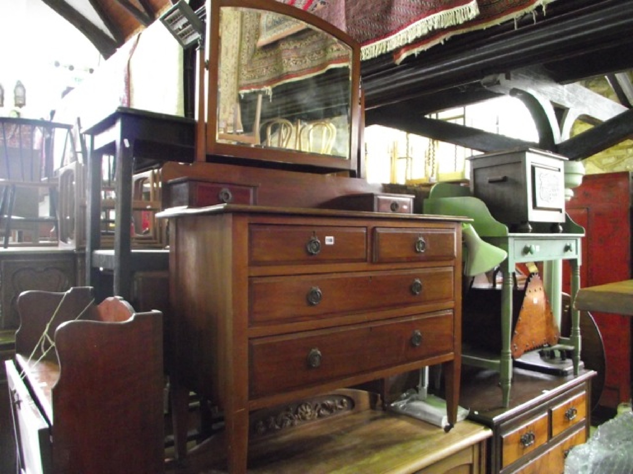 Appraisal: An Edwardian mahogany dressing chest the raised rectangular arched swing