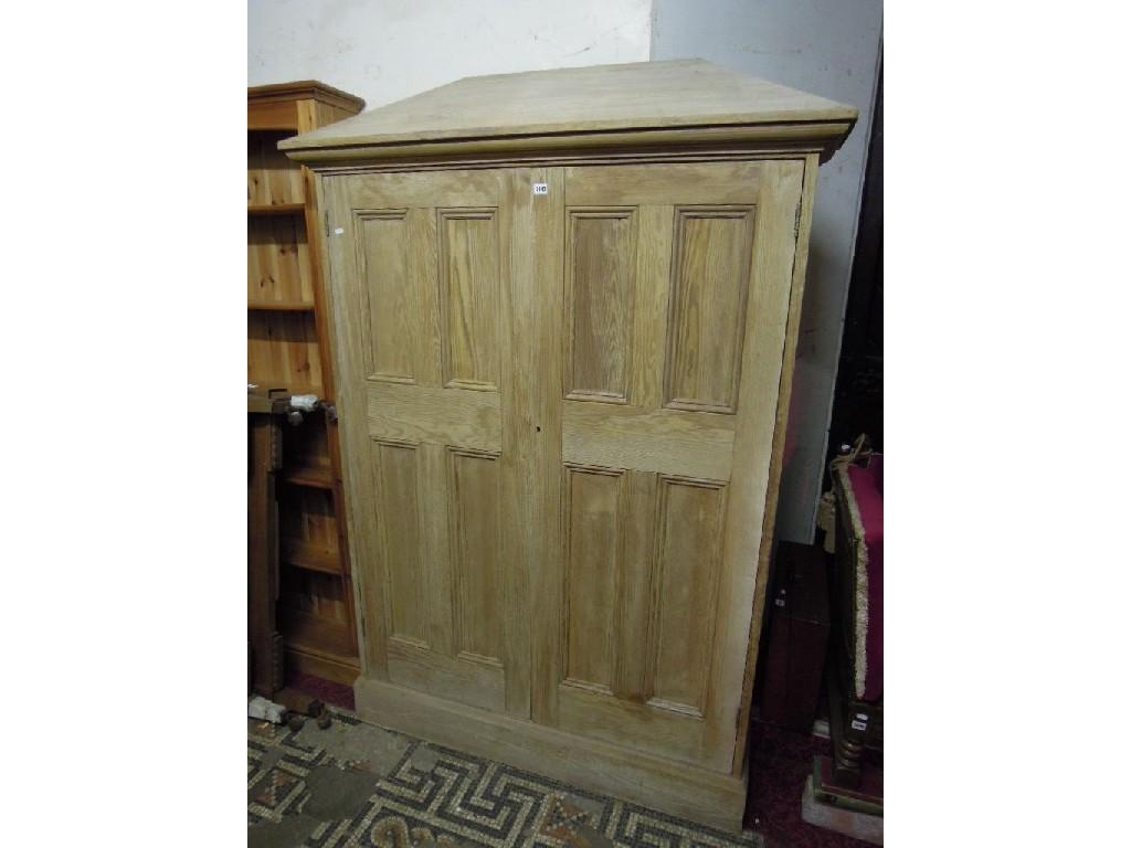 Appraisal: A slender pitch pine side cupboard with tapered pediment over