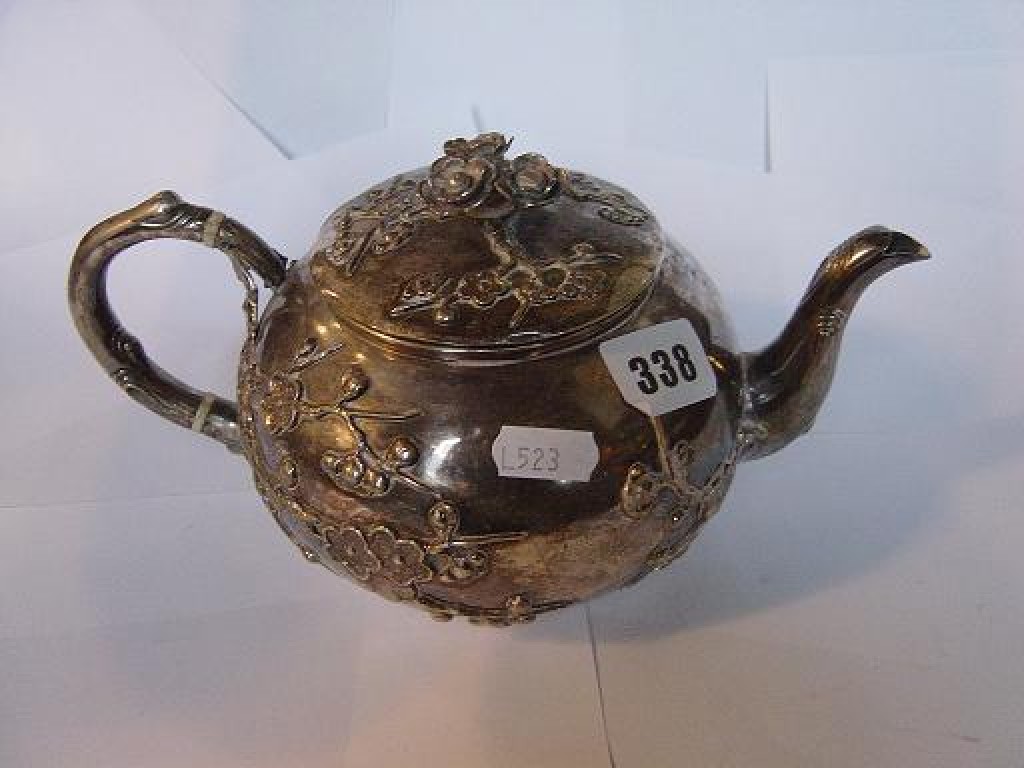 Appraisal: A Chinese white metal teapot of squat baluster form with