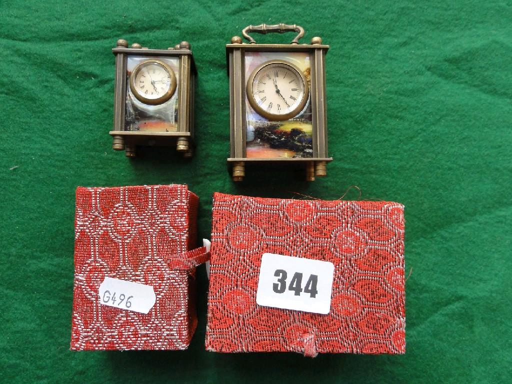 Appraisal: Two modern brass miniature carriage clocks decorated with erotic scenes