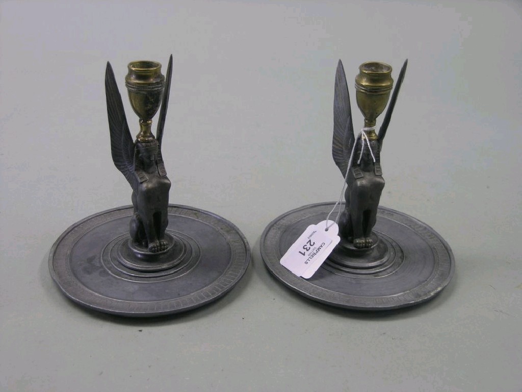 Appraisal: A pair of pewter candlesticks each stem in the form