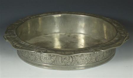 Appraisal: A th century large twin handled pewter barbers bowl with