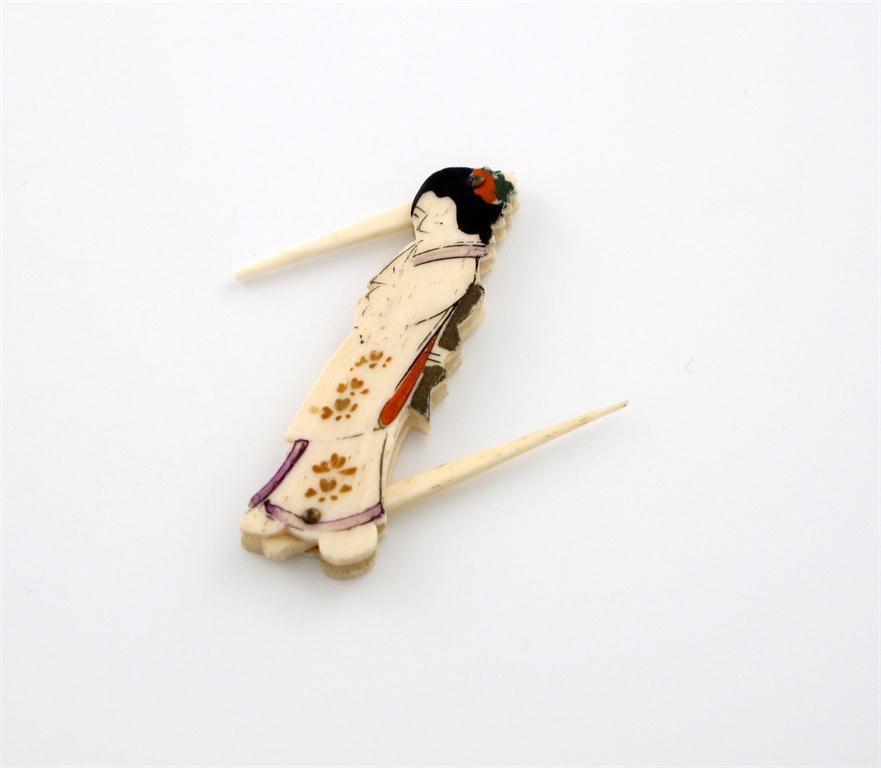 Appraisal: A Japanese carved bone figural toothpick